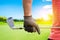 Golfer holding golf club by glove hand to preparing in golf game with sunlight rays