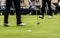 Golfer legs at golf tournament practice swing with golf club