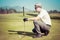 Golfer looking golf shot with club