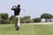 Golfer making fairway shot