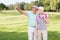 Golfer man pointing while standing by woman