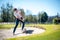 Golfer playing a chip shot onto the green