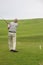 A golfer plays golf on the golf course of St Bees, England.