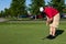 Golfer practicing putting golf balls