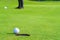 Golfer putt golf ball into hole on the green at golf course