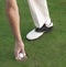 Golfer\'s hand picking ball out of hole