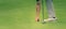 Golfer is taking the ball out of the hole