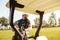 Golfer taking clubs from a bag in a golf cart