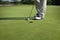 Golfer tapping in short putt