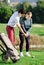 Golfer teaches a  woman to play