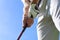 Golfer wearing a golf holding a putter