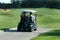 Golfers on cart.