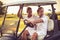 Golfers couple are riding in a golf cart