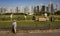 Golfers practice on driving range with Dubai skyline in the background