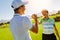 Golfers shaking hands at golf course