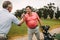 Golfers shaking hands after a successful practise session