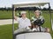 Golfers Sitting In Golf Cart