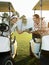 Golfers Sitting In Golf Carts Holding Score Card