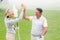 Golfing couple high fiving