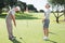 Golfing couple on the putting green at the eighteenth hole