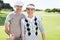 Golfing couple smiling at camera on the putting green