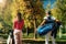 Golfing couple, walking to the next hole, shot from behind, beautiful autumn weather