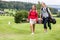 Golfing couple walking together on golf course