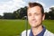 Golfing puts a smile on his face. Smiling mature man holding his golf club while on the course - closeup.