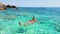 Golfo di Orosei Sardina, Men swimming in the ocean with crystal clear blue water in Italy