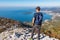 Goli Vrh - Hiking man with backpack enjoying panoramic aerial view on coastline of Budva and Sveti Nikola, Montenegro