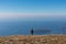 Goli Vrh - Hiking woman with backpack enjoying panoramic aerial view on coastline of Budva and Sveti Nikola, Montenegro