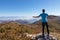 Goli Vrh - Man on top of Goli Vrh with scenic aerial view on Dinaric Alps surrounding Lake Skadar National Park, Montenegro