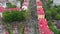 Gomel, Belarus - 05/09/2019: Crowd of people on a city festive street, top view, vertical flight over the roofs of bright houses