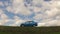 GOMEL, BELARUS - 16 April 2017: The car is parked in the field against the sky with clouds