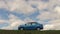 GOMEL, BELARUS - 16 April 2017: The car is parked in the field against the sky with clouds