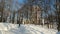 Gomel, Belarus - January 27, 2019: people walking in snowy city park near Rumyantsev-Paskevich Palace In Sunny Winter