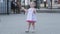 Gomel, Belarus - June 18, 2021: a little beautiful girl in a dress is dancing on the street in the park 2021