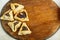 Gomentashi cookies for Purim holiday on a table on a wooden board. save a place.