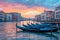 gondola boats are tied up next to buildings along the water in venice