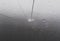 A gondola cuts its way through the mist and fog