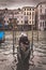 Gondola docked in canal in Venice