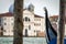 Gondola docked in Venice with wooden pylons in the foreground an