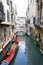 Gondola with a gondolier on the water of the canal in Venice, Italy