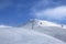 Gondola lift and off-piste ski slope in fog at nice sunny evening. Caucasus Mountains in winter, Georgia, region Gudauri, mount