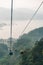 Gondola lifts moving over mountain with green trees in the area of Sun Moon Lake Ropeway in Yuchi Township, Nantou County, Taiwan