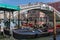 Gondola parking near the famous Realto bridge on a Grand Canal in Venice with the Servizio Gondole sign