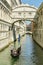 Gondola riding under Bridge of Sighs close to San Marco Square in Venice, Italy