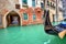 Gondola on small canal in Venice, Italy.