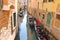Gondolas and boats in a narrow canal in Venice