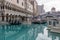 Gondolas docked along the blue waters surrounded by hotels at The Venetian Hotel and resort in Las Vegas Nevada